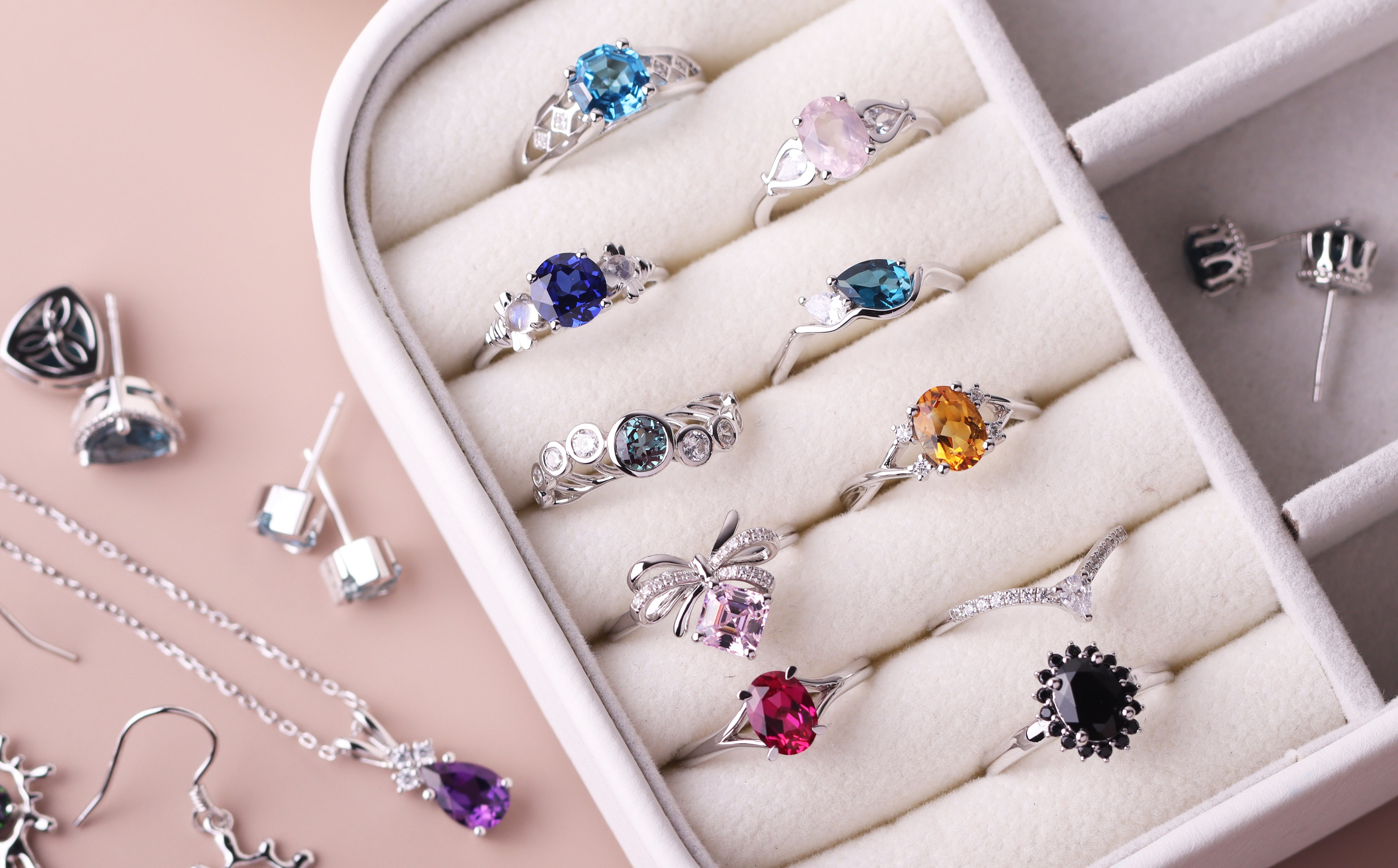 Gemstone engagement rings and gemstone jewelry in a jewelry box.