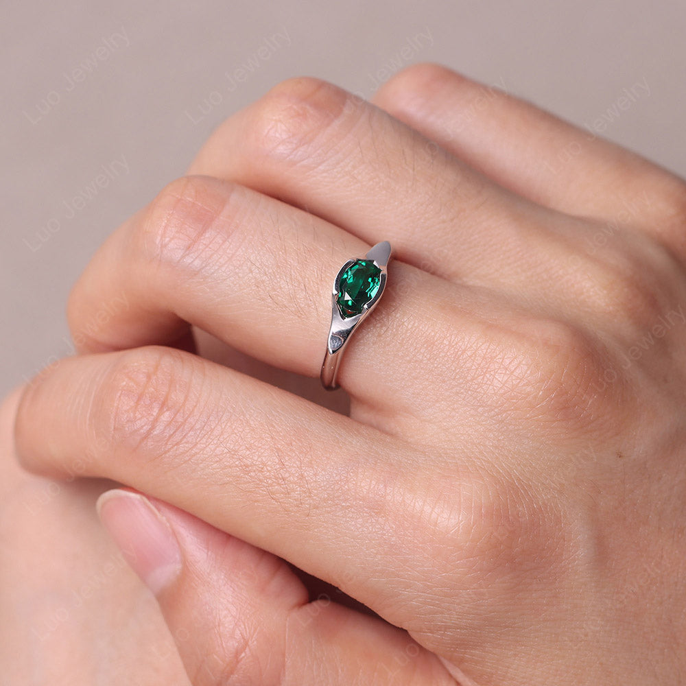 Oval Emerald East West Bezel Set Ring