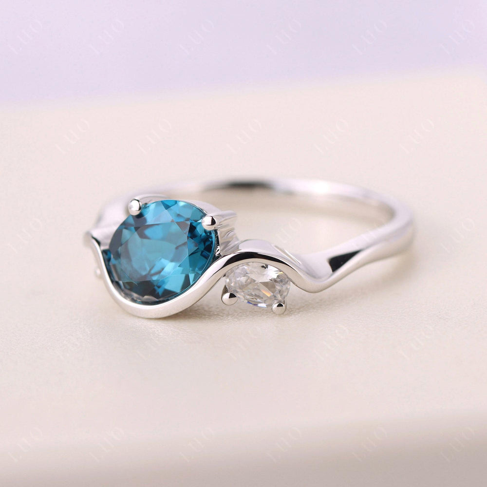 Wave Oval London Blue Topaz Engagement Ring