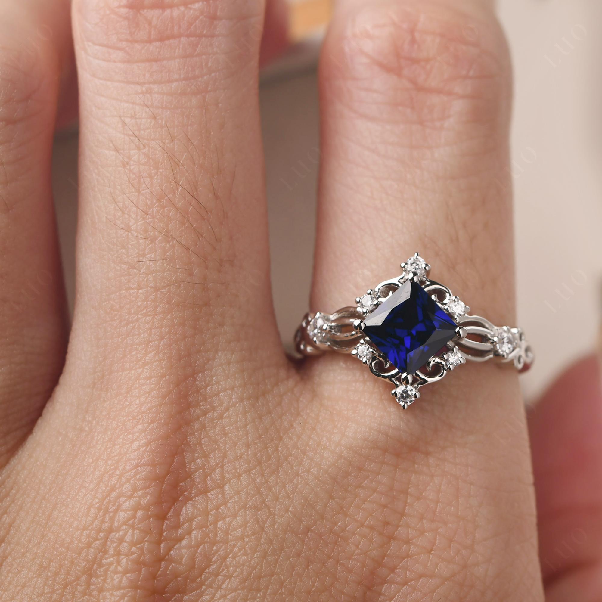 Princess cut Blue sapphire ring in bezel settings and tiny diamond wit